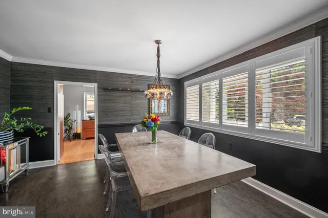 a view of a hallway with furniture and a window