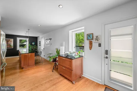 a spacious bedroom with a bed and wooden floor