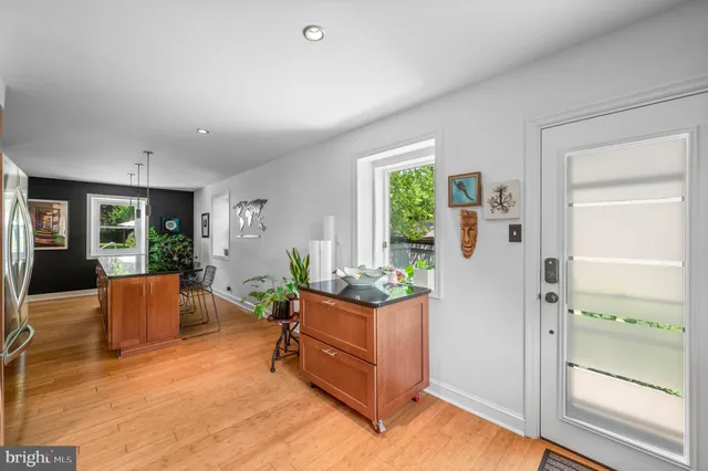 a spacious bedroom with a bed and wooden floor