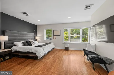 a bedroom with a bed and a painting on the wall