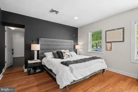 a bedroom with a bed and a large mirror