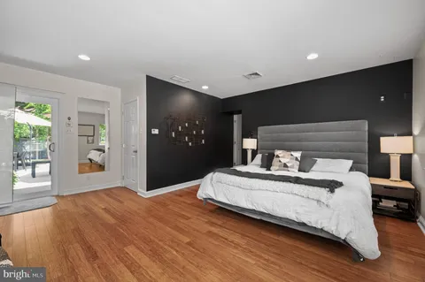 a bedroom with a bed and a large window