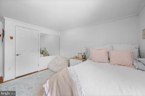 a view of a patio with couches table and chairs under an umbrella