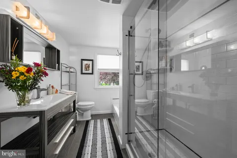 a view of backyard with swimming pool and seating space