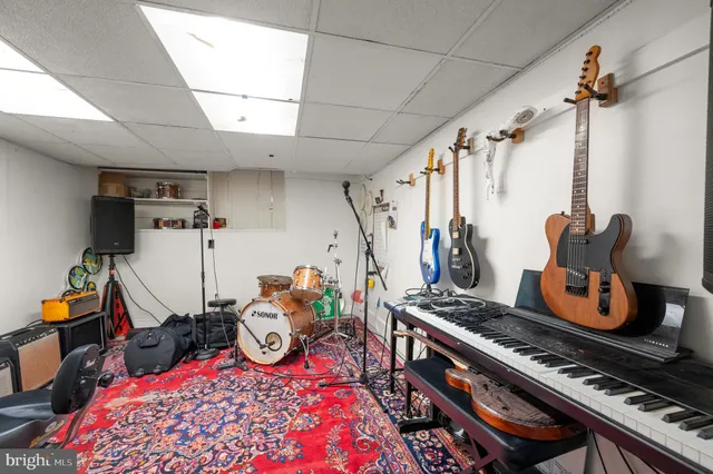 an aerial view of residential house with outdoor space and trees all around
