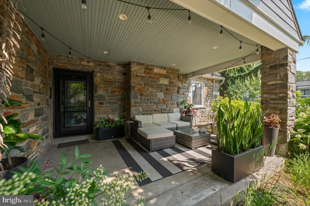 a view of a dining room and livingroom with furniture wooden floor a chandelier