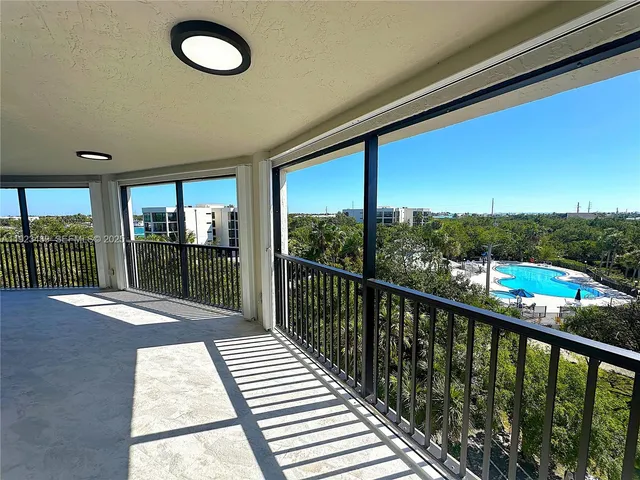 a view of a balcony with wooden floor