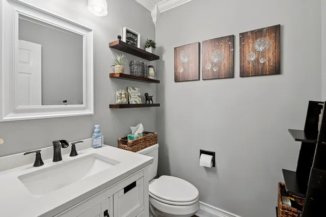 a bathroom with a toilet a sink and a mirror