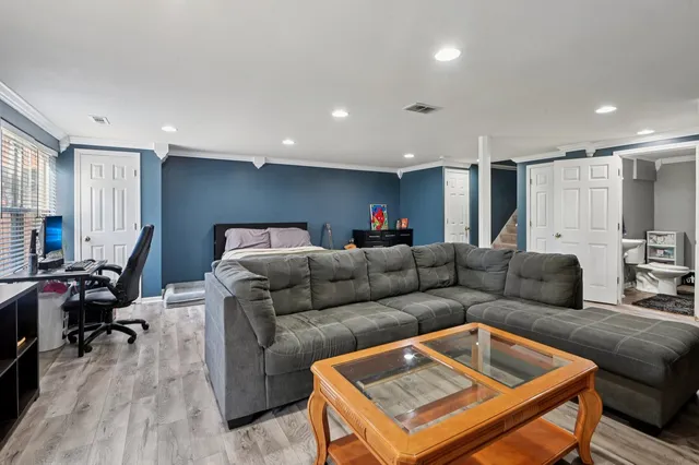 a living room with furniture and a wooden floor