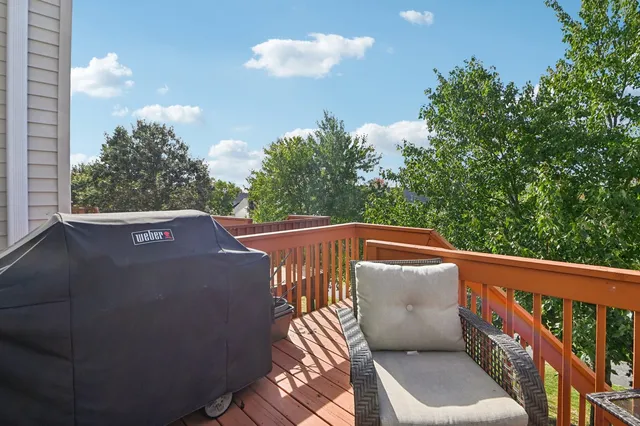 a view of a balcony with wooden floor and fence