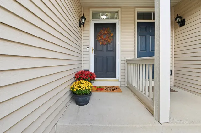 a bunch of flowers in front of a house