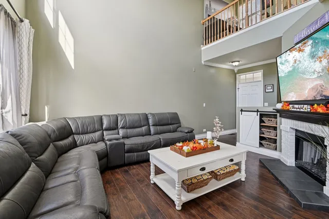 a living room with furniture fireplace and flat screen tv
