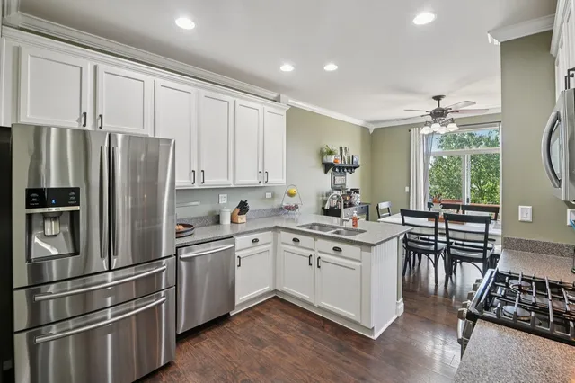 a kitchen with stainless steel appliances a sink stove and refrigerator