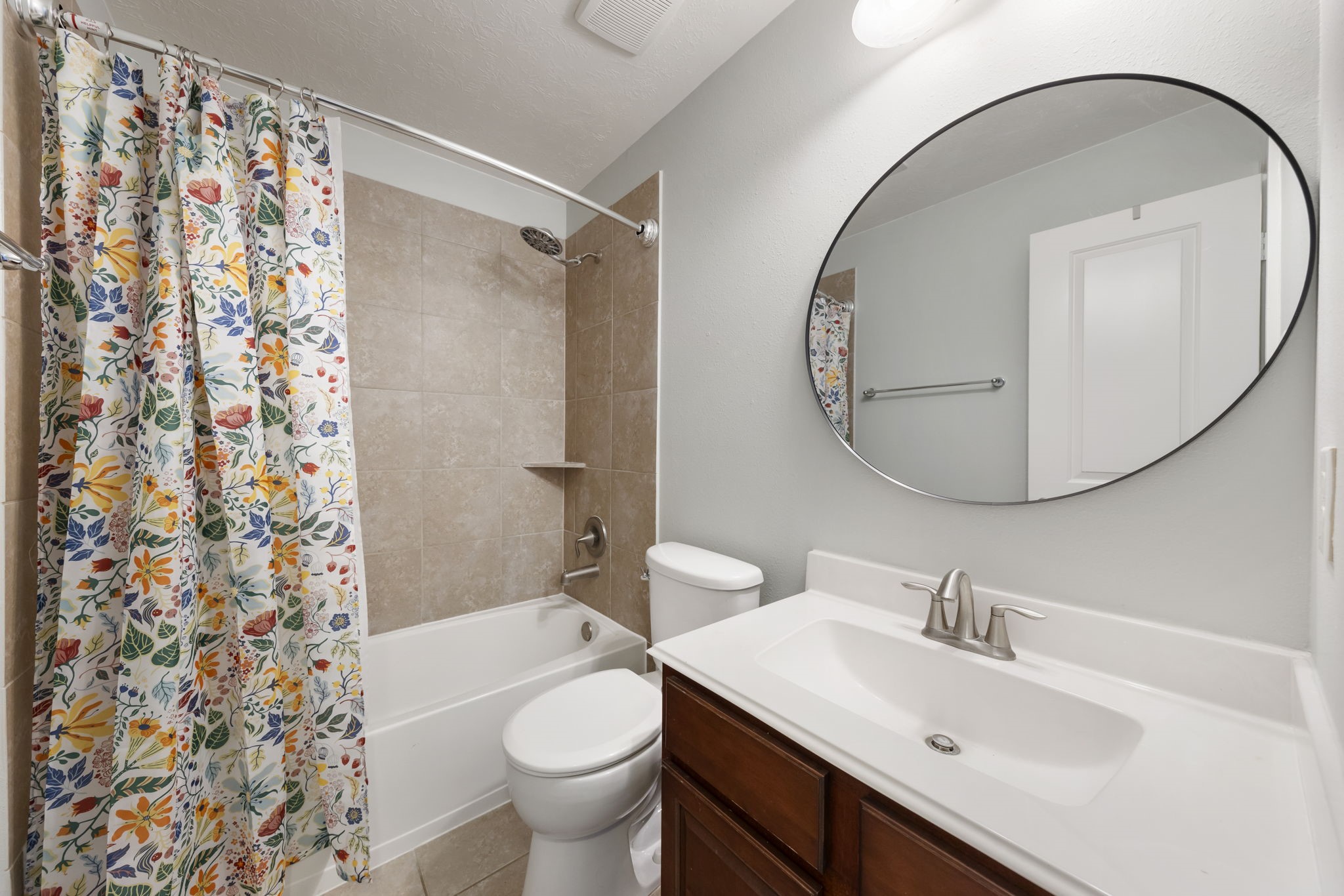 3318 Solvista High Court Spring, TX 77386 - Photo 21 of 33 Upstairs secondary bath features a spacious vanity, tub and shower combination with tile surround, and timeless finishes designed for comfort and convenience.