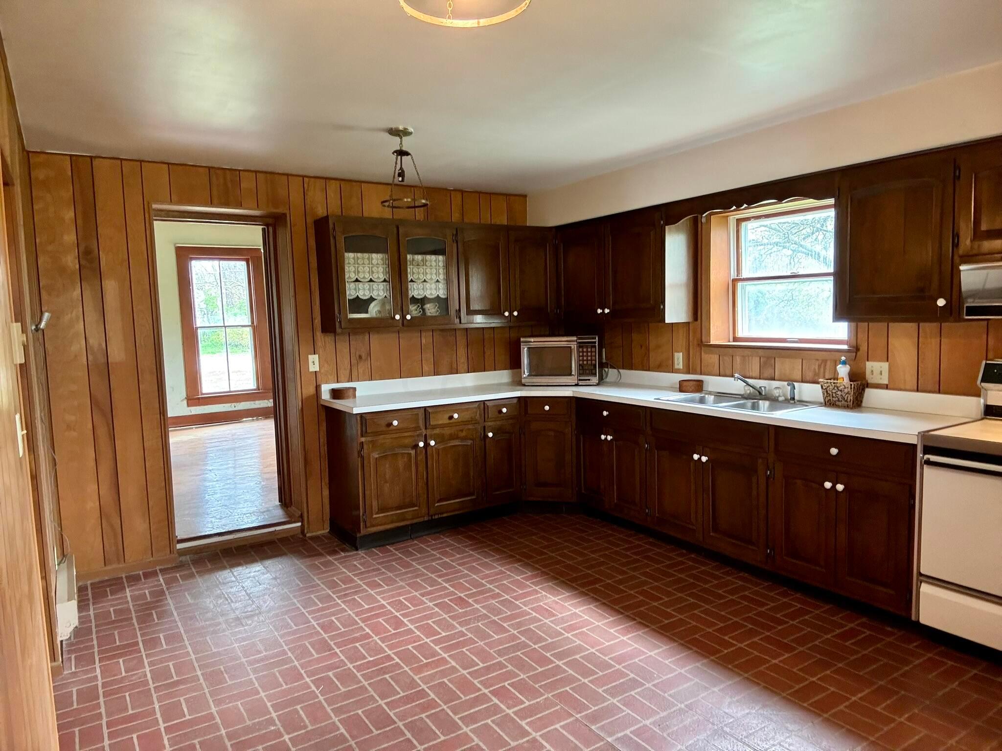 2190 Rosedale Road Irwin, OH 43029 - Photo 4 of 42 Vinyl flooring. Two upper glass display upper cabinets near doorway to the living room. Ample countertop space and appears to be in good condition.