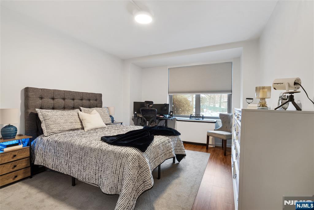 301 Beech Street, Unit 2B Hackensack, NJ 07601 - Photo 14 of 21 a bedroom with a bed and wooden floor