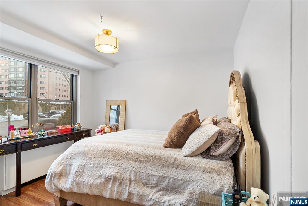 301 Beech Street, Unit 2B Hackensack, NJ 07601 - Photo 17 of 21 a bedroom with a bed and a window