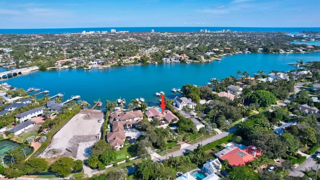 an aerial view of lake and residential houses with outdoor space