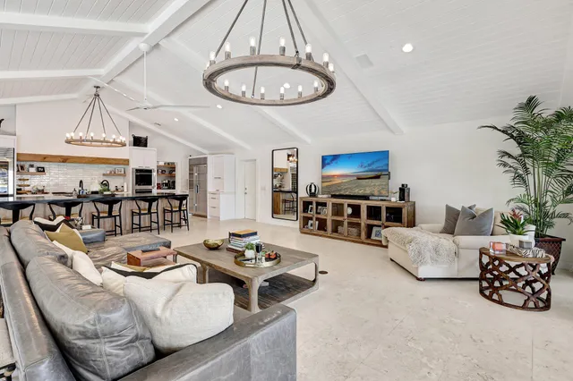 a kitchen with stainless steel appliances a stove a sink dishwasher a kitchen island with wooden cabinets and floor