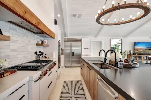 a kitchen with stainless steel appliances a sink and a wooden cabinets
