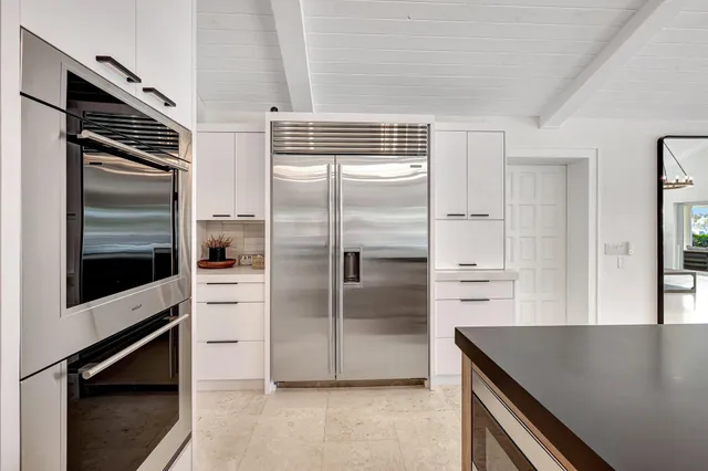 a kitchen with stainless steel appliances a stove and cabinets