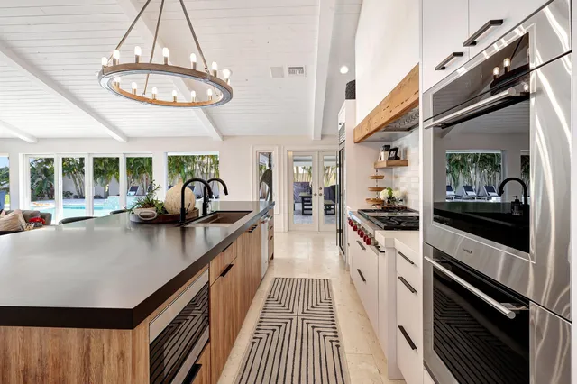 a view of a balcony with table and chairs potted plants