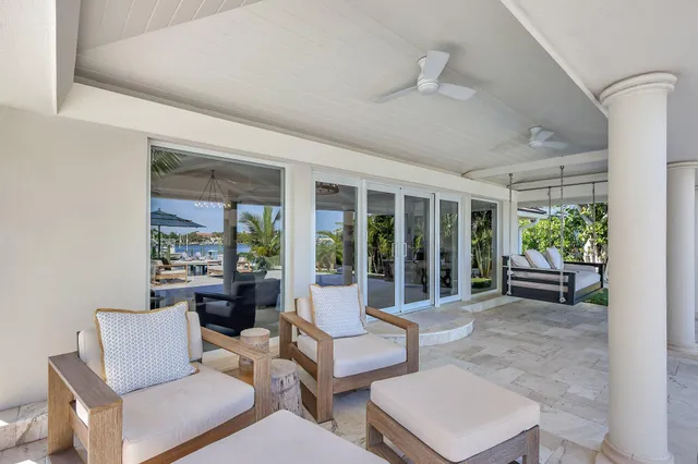 a view of a house with backyard and sitting area