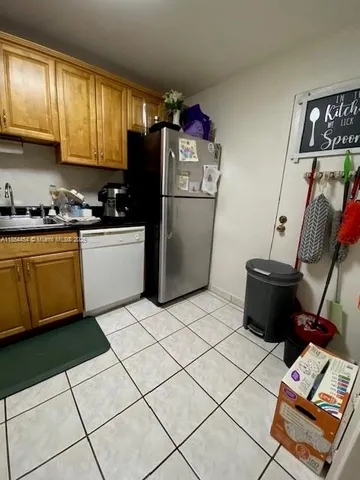 a kitchen with stainless steel appliances granite countertop a refrigerator sink and cabinets
