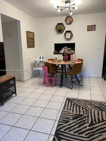 a view of a dining room with furniture and chandelier
