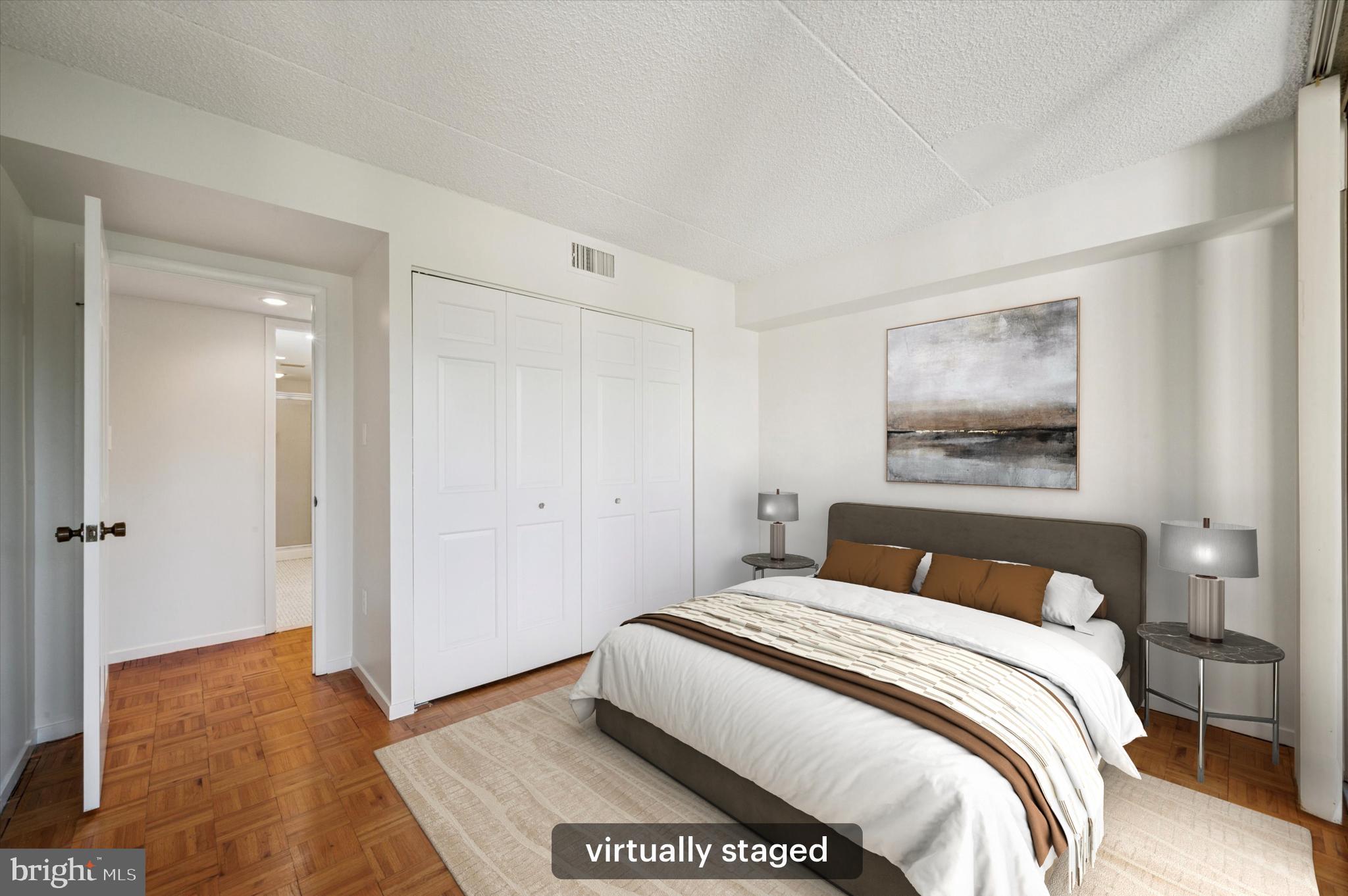 19 Rock Hill Road, Unit 7D Bala Cynwyd, PA 19004 - Photo 22 of 37 a bedroom with a bed and a painting on the wall