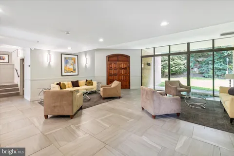 a living room with furniture and large windows