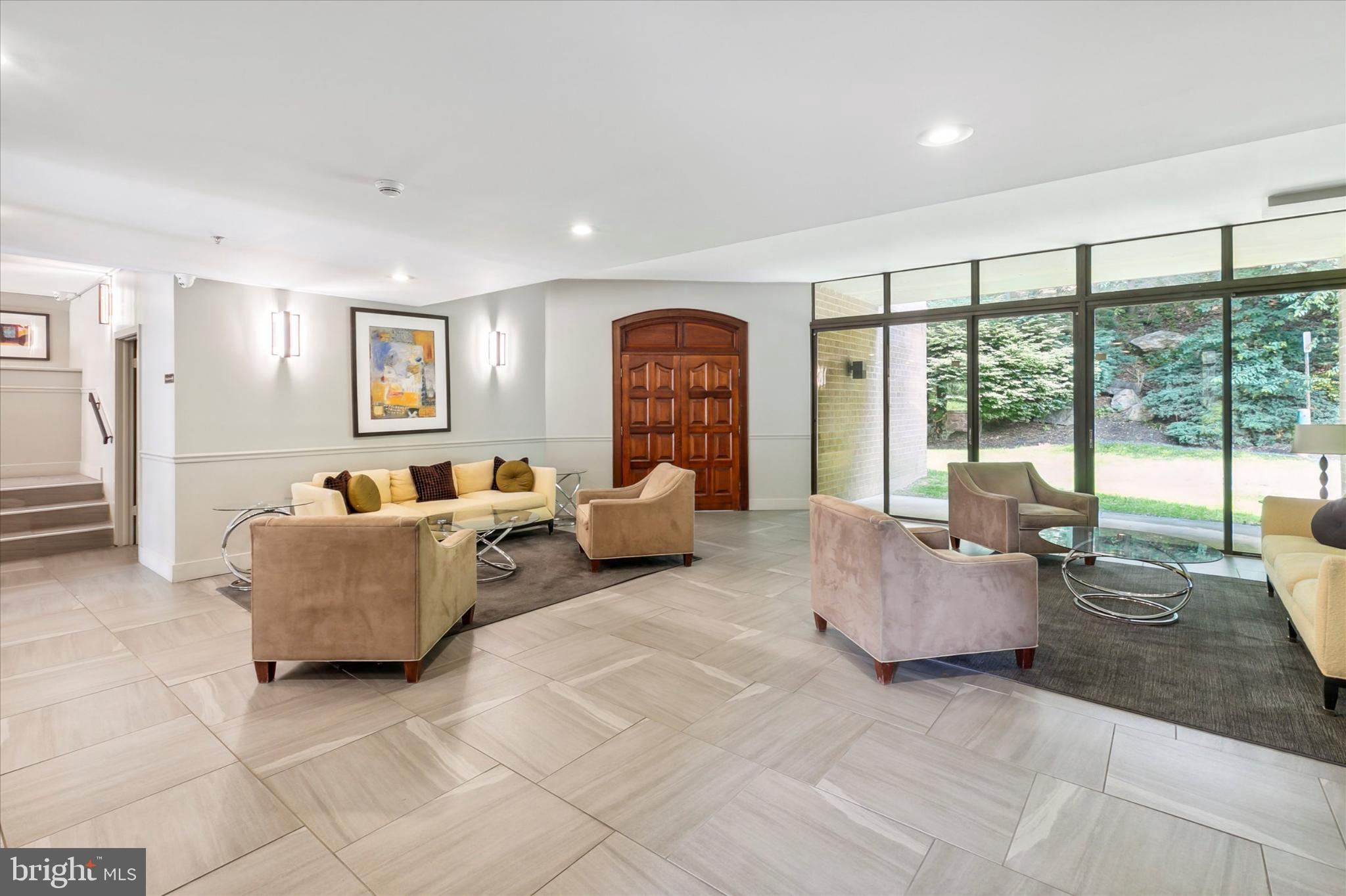 19 Rock Hill Road, Unit 7D Bala Cynwyd, PA 19004 - Photo 5 of 37 a living room with furniture and large windows