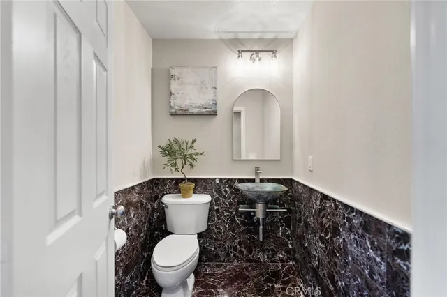 a bathroom with a shower sink and mirror