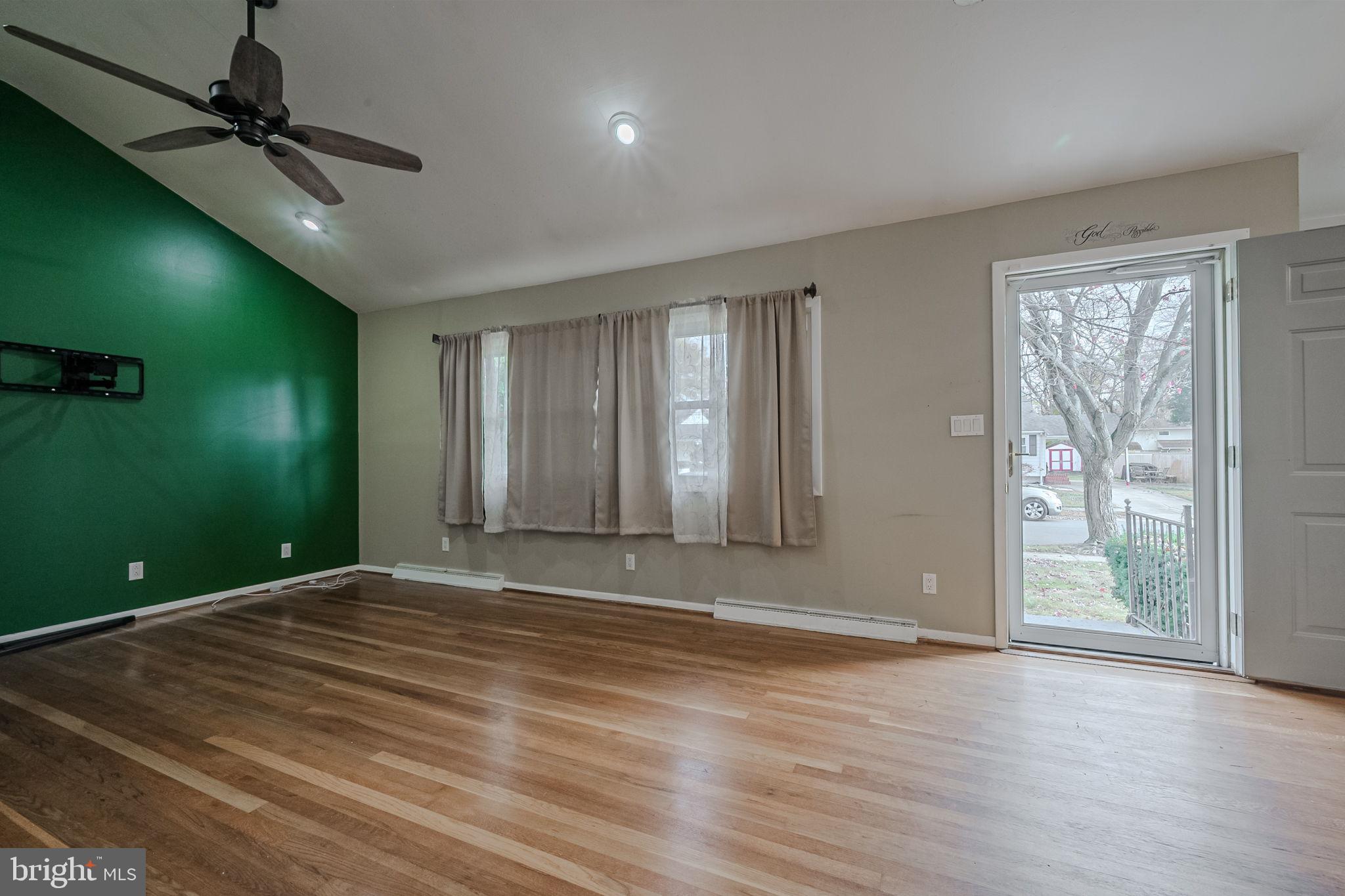 6 Merion Road Newark, DE 19713 - Photo 5 of 36 a view of an empty room with window and hardwood floor