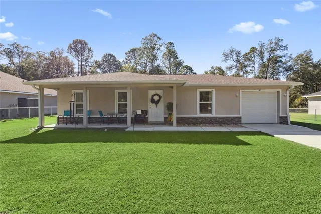 a view of a house with backyard porch and sitting area