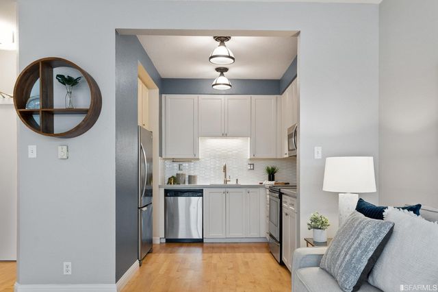 a view of living room with granite countertop furniture a rug and a chandelier
