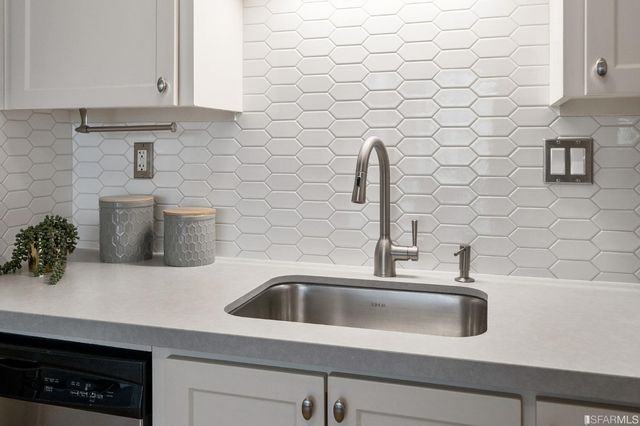 a close view of a sink and dishwasher in a kitchen