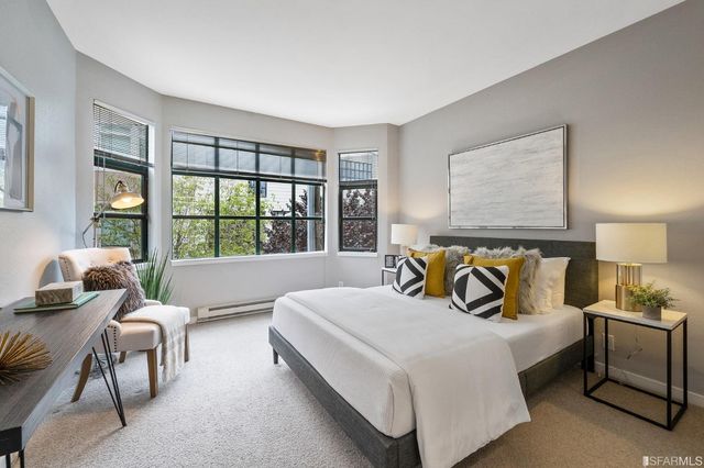 a bedroom with bed and a large window