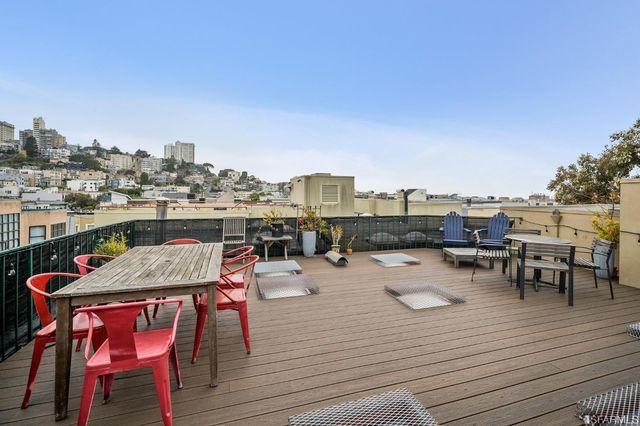 a view of a terrace with furniture and a kitchen