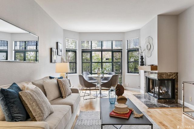 a living room with furniture large window and a fireplace