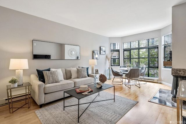 a living room with furniture and a floor to ceiling window