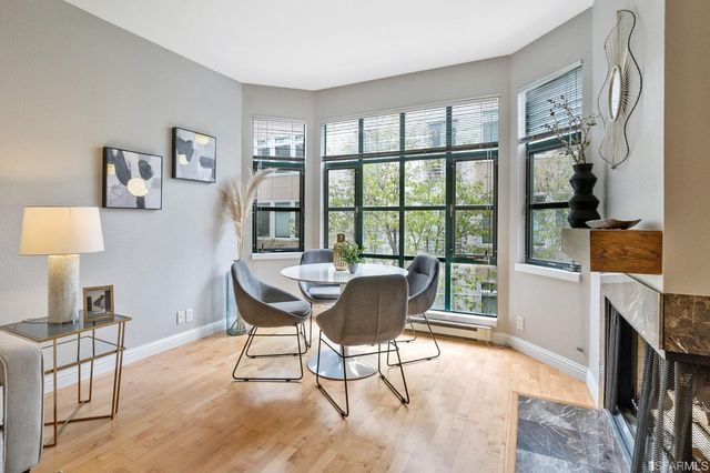 a dining room with furniture and wooden floor