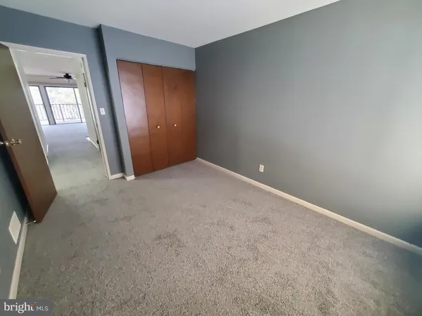 an empty room with mirror and entrance