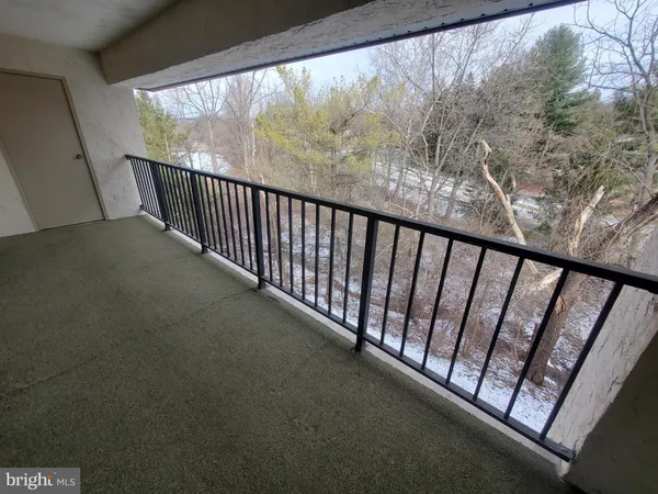 a view of balcony with wooden floor