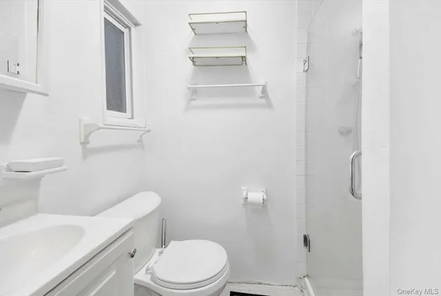 a white toilet sitting next to a bathroom sink