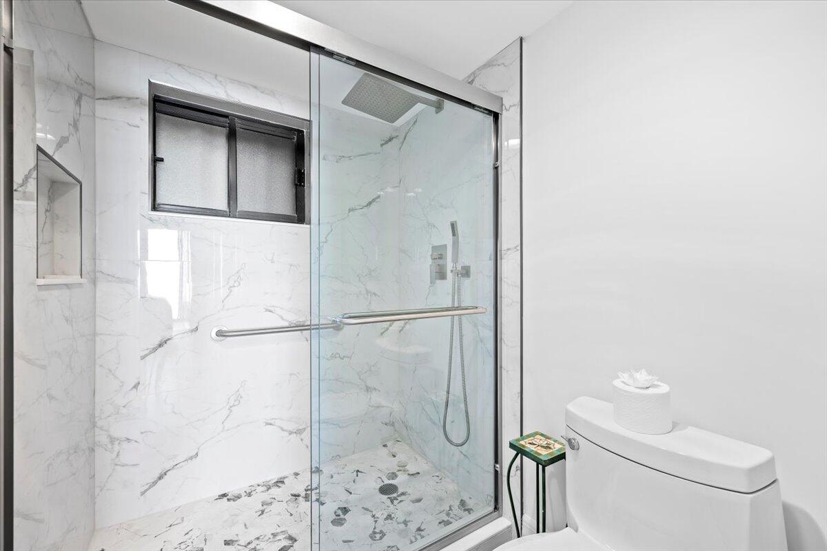 400 Ocean Trail Way, Unit 504 Jupiter, FL 33477 - Photo 11 of 27 a bathroom with a shower and a toilet