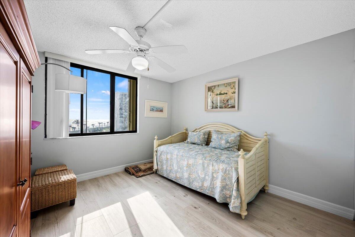 400 Ocean Trail Way, Unit 504 Jupiter, FL 33477 - Photo 12 of 27 a bedroom with a bed and a window