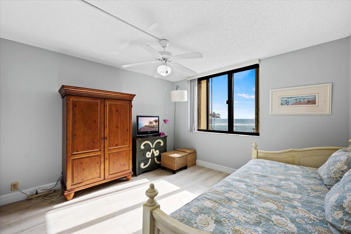 400 Ocean Trail Way, Unit 504 Jupiter, FL 33477 - Photo 13 of 27 a bedroom with a bed and a dresser