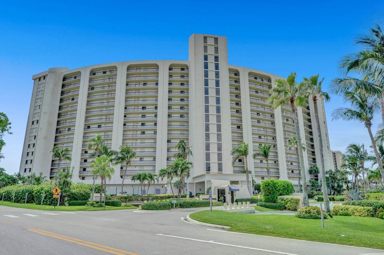 400 Ocean Trail Way, Unit 504 Jupiter, FL 33477 - Photo 2 of 27 a front view of a residential apartment building with a yard