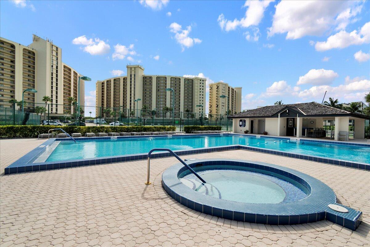 400 Ocean Trail Way, Unit 504 Jupiter, FL 33477 - Photo 22 of 27 a swimming pool with outdoor seating and yard